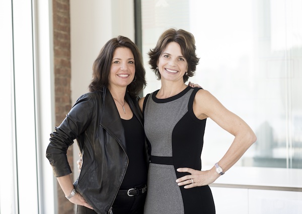 Fast Forward founders and authors Wendy Leshgold and Lisa McCarthy stand together arm in arm smiling